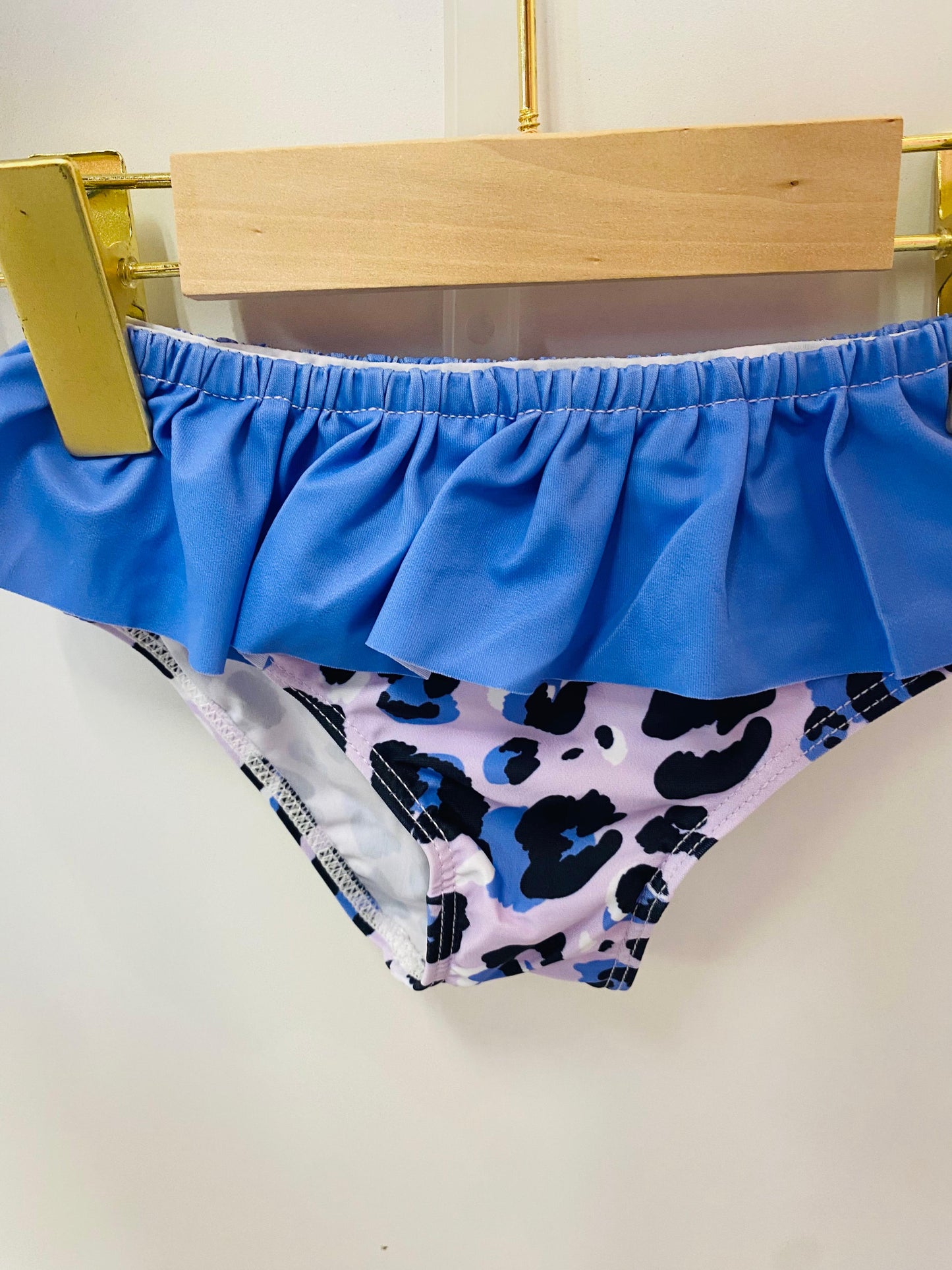 purple swim bottom with leopard print pattern on a white background
