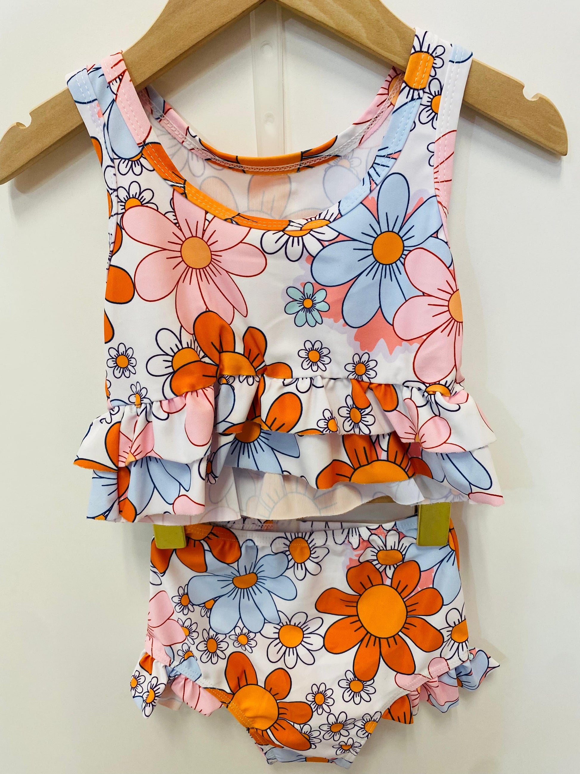 Floral swimsuit with orange and blue flowers.