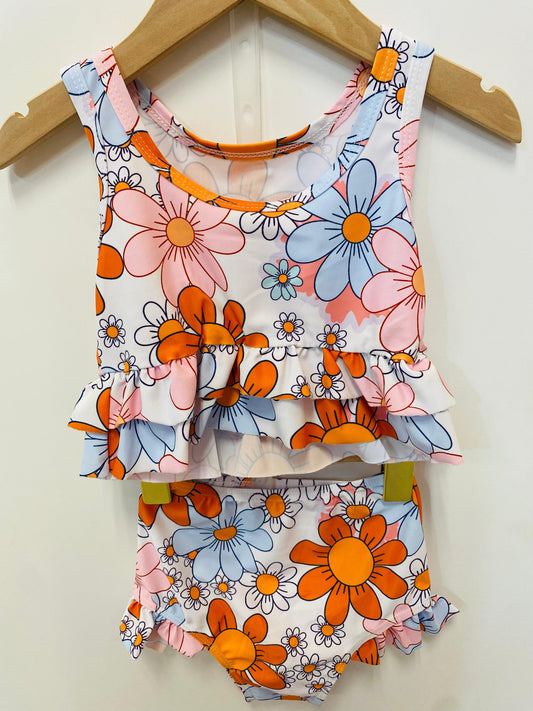 Floral swimsuit with orange and blue flowers.