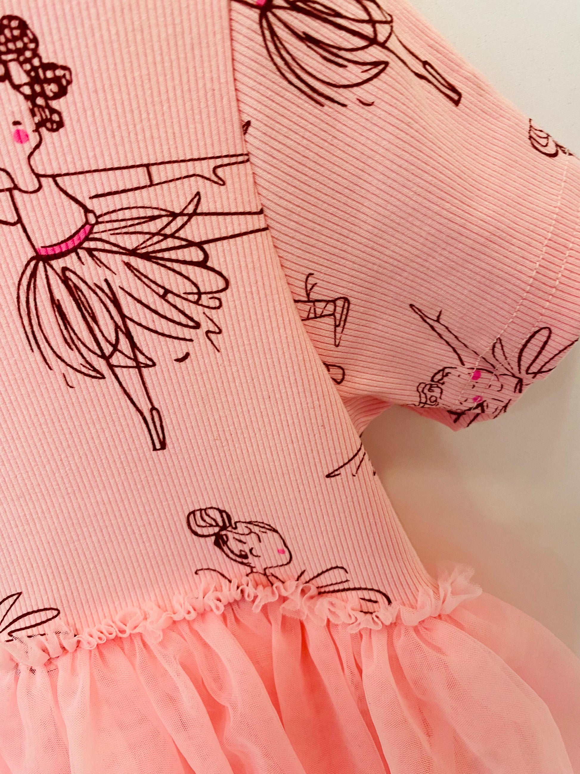 Pink dress with black line art of a ballerina on a light pink background