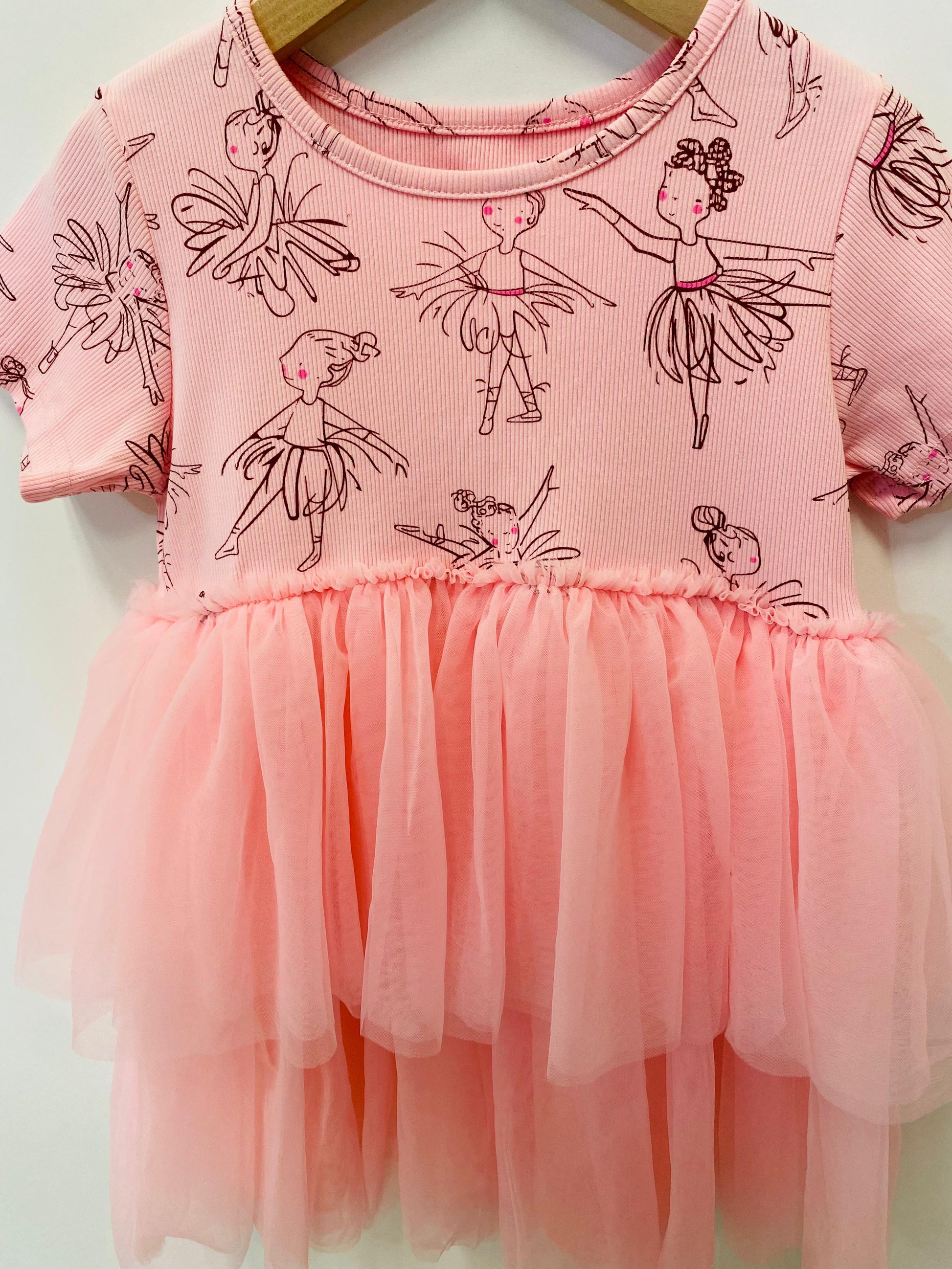 Pink dress with ballerina print on a white background